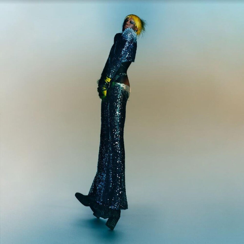 the album cover for Yves Tumor - Praise A Lord Who Chews But Which Does Not Consume; (Or Simply, Hot Between Worlds) [Transparent Yellow LP]