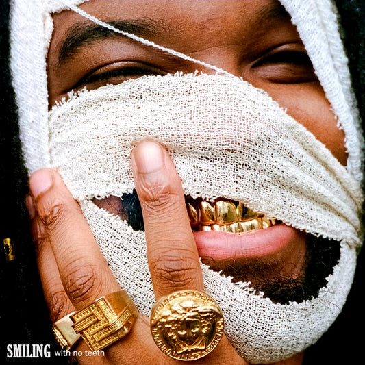 the album cover for Genesis Owusu - Smiling With No Teeth [Colored Vinyl] (Red)
